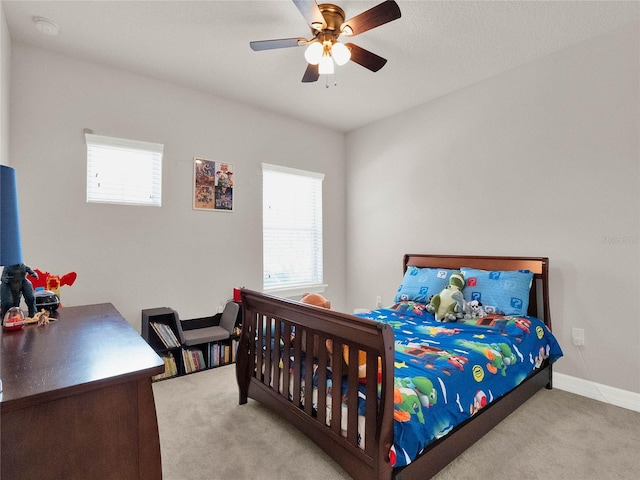 bedroom featuring multiple windows, baseboards, and carpet floors