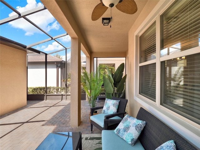 view of patio featuring a lanai and ceiling fan