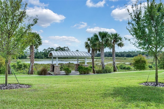 view of home's community with a gazebo, a yard, and a water view