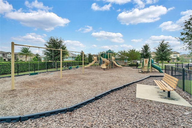 community playground featuring a residential view and fence