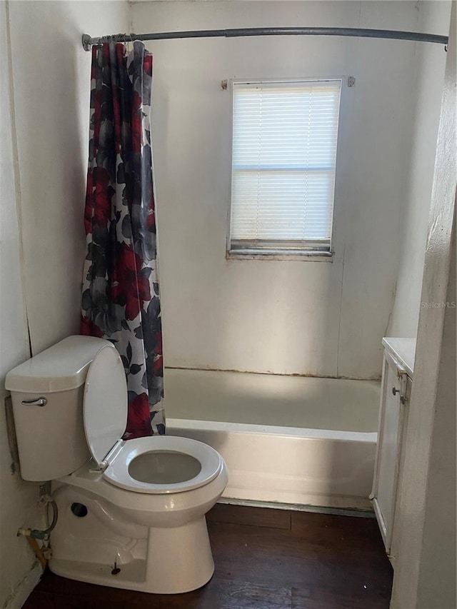 full bathroom with vanity, shower / tub combo, toilet, and wood finished floors