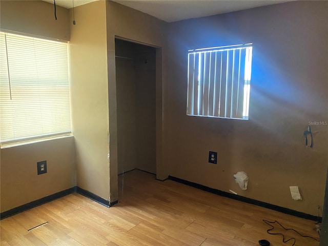 unfurnished bedroom with light wood-style floors and baseboards