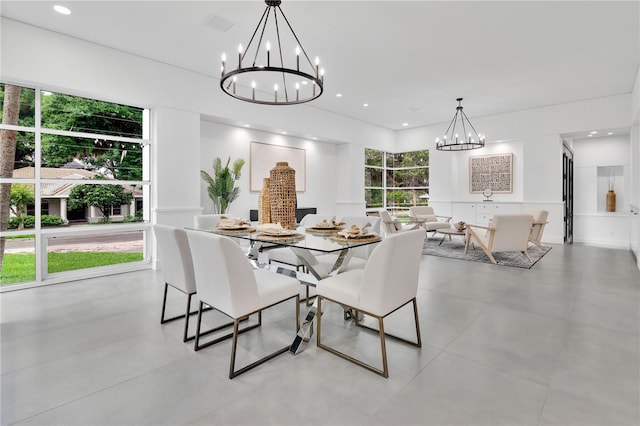 dining room with a chandelier and recessed lighting