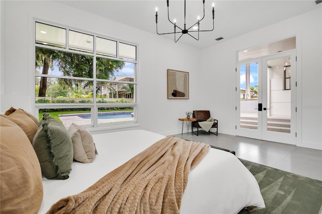 bedroom with french doors, multiple windows, a chandelier, and baseboards