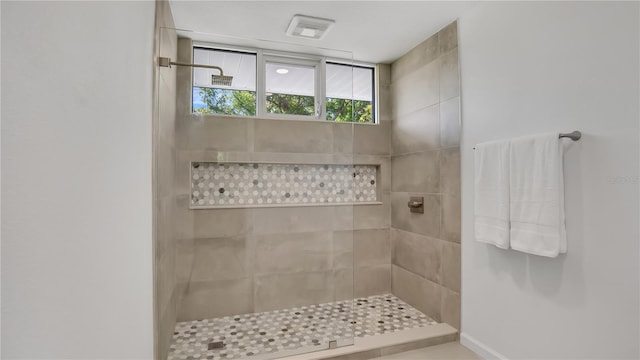 full bath featuring tiled shower
