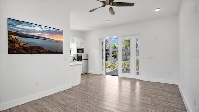 unfurnished living room featuring wood finished floors, ceiling fan, baseboards, and recessed lighting