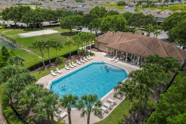 community pool featuring a patio area and fence