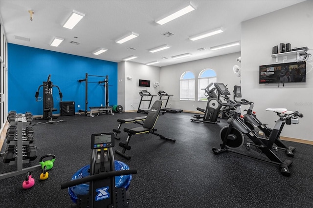 exercise room with visible vents and baseboards