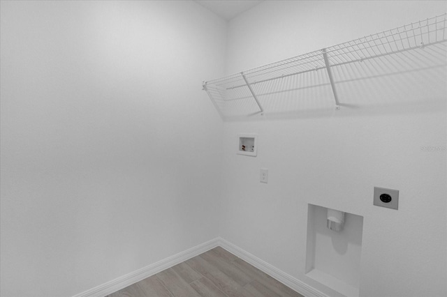 laundry area featuring electric dryer hookup, washer hookup, light wood-style floors, baseboards, and laundry area