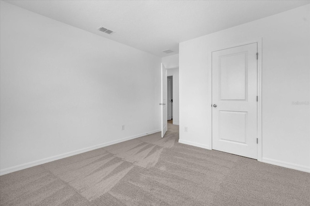 spare room featuring visible vents, baseboards, and carpet floors