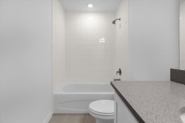 bathroom featuring tub / shower combination, toilet, vanity, and tile patterned flooring