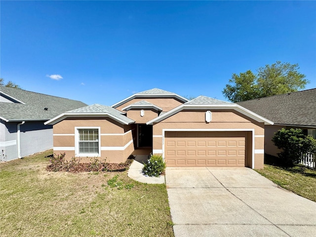 ranch-style house with stucco siding, roof with shingles, concrete driveway, a front yard, and a garage