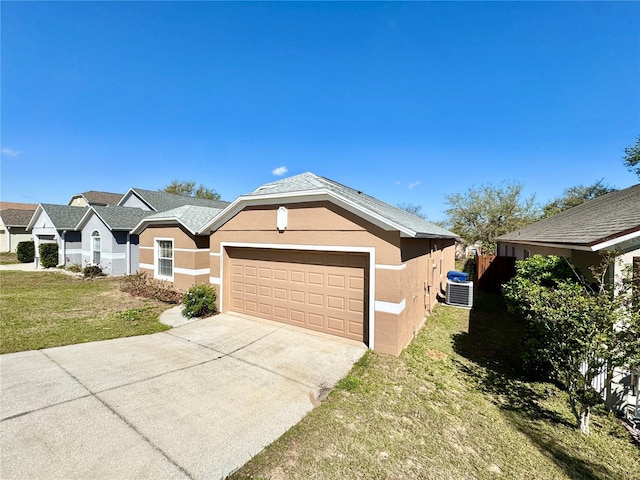 view of front of home with a front lawn, concrete driveway, stucco siding, cooling unit, and a garage