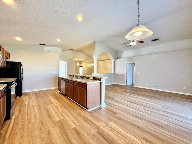 kitchen with light wood finished floors, visible vents, dishwasher, vaulted ceiling, and electric range