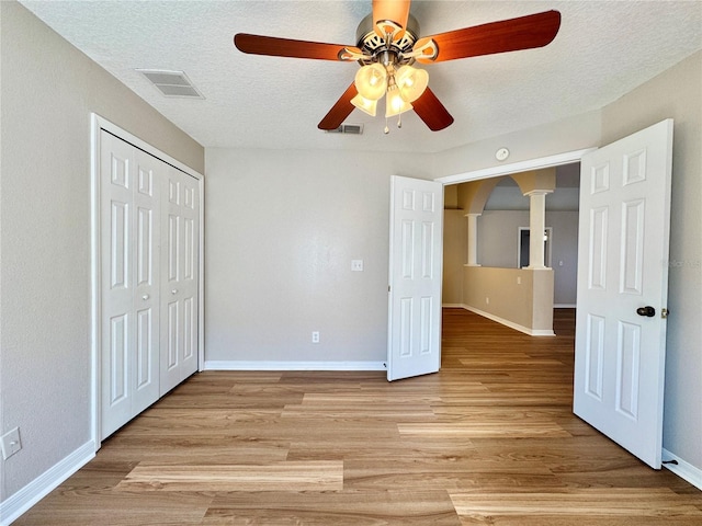 unfurnished bedroom with baseboards, visible vents, and light wood finished floors