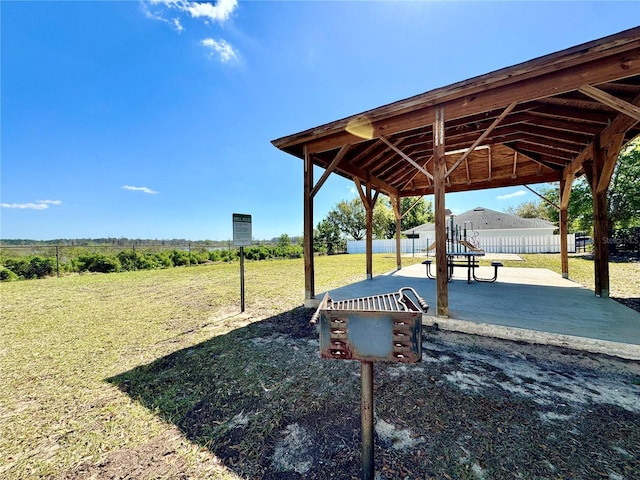 surrounding community with a gazebo, a patio area, a lawn, and fence