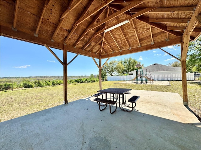 view of patio / terrace with a playground and a fenced backyard