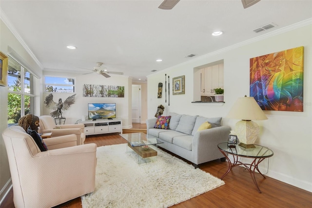 living room with visible vents, wood finished floors, recessed lighting, crown molding, and ceiling fan