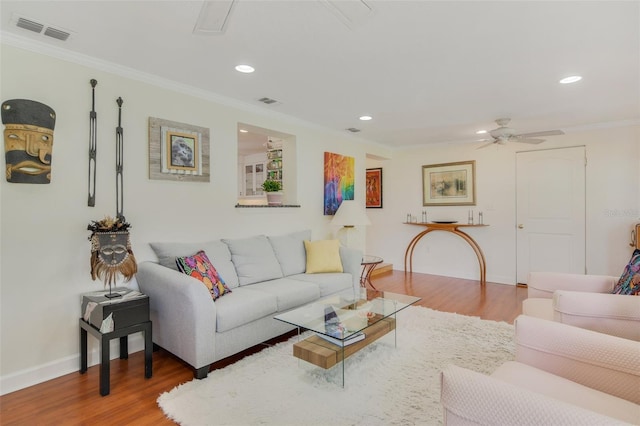 living room featuring crown molding, wood finished floors, visible vents, and ceiling fan