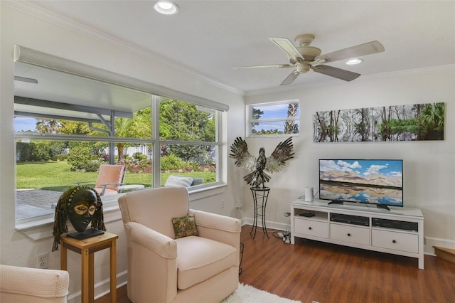 living area with wood finished floors, baseboards, recessed lighting, ceiling fan, and ornamental molding