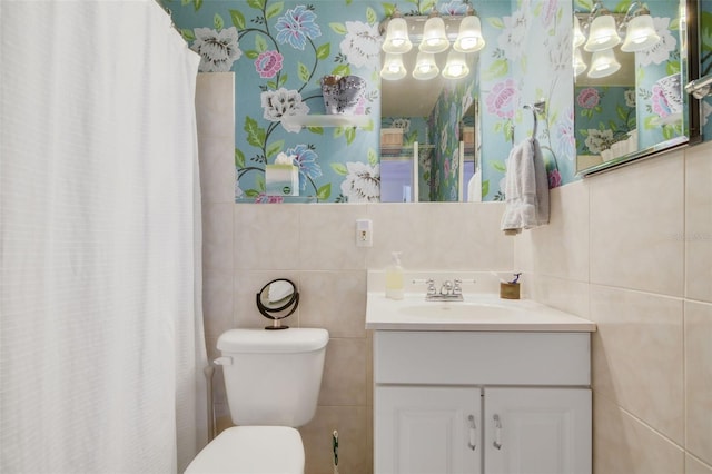 full bathroom with vanity, a shower with curtain, wallpapered walls, tile walls, and toilet