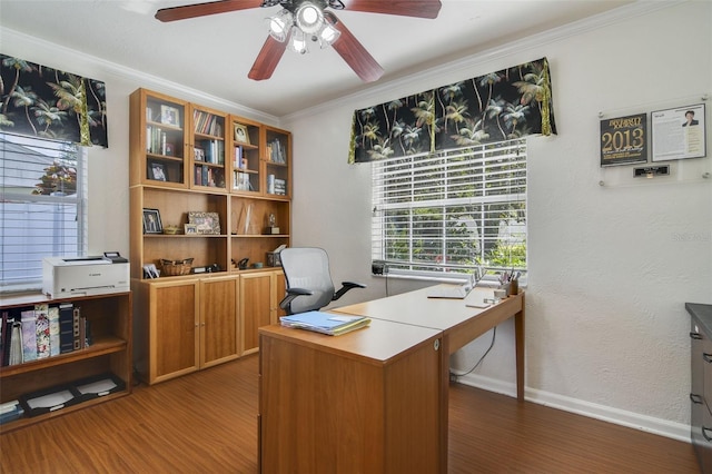 home office with ornamental molding, wood finished floors, baseboards, and ceiling fan