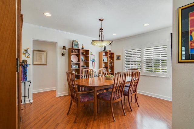 dining area with crown molding, recessed lighting, wood finished floors, and baseboards