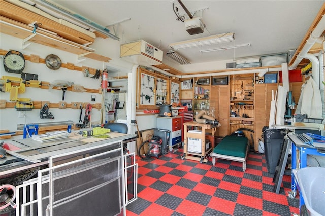 garage with a workshop area and a garage door opener