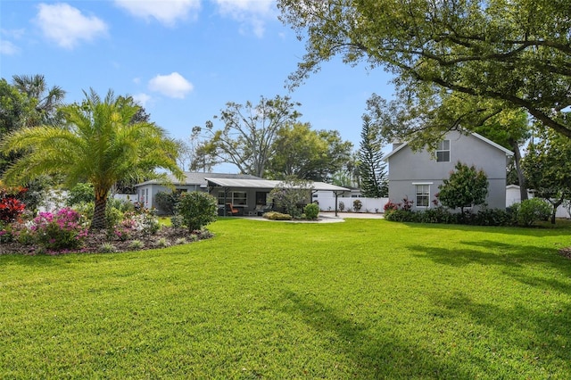 view of yard with concrete driveway