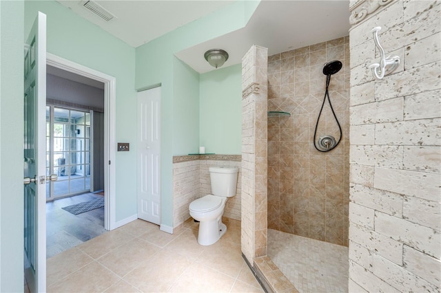 full bathroom with tile patterned floors, visible vents, toilet, and walk in shower