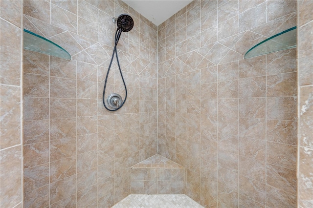 full bath with a tile shower