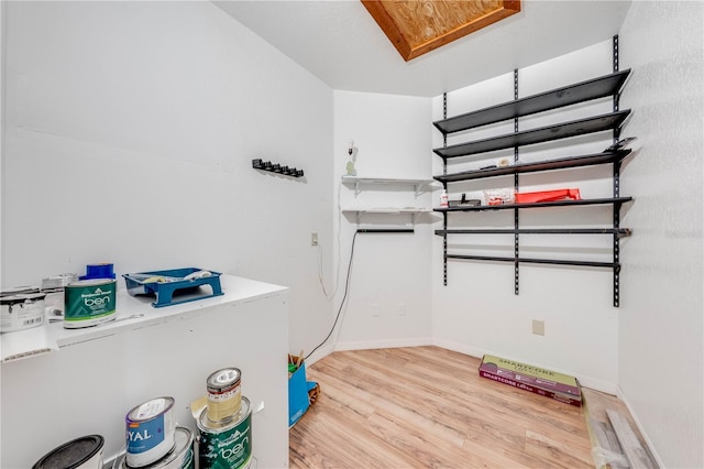 washroom featuring wood finished floors and baseboards