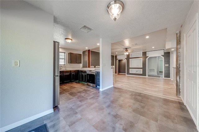 kitchen with visible vents, ceiling fan, open floor plan, light countertops, and stainless steel appliances