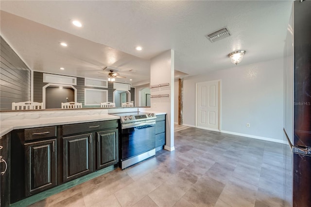 kitchen with electric range, visible vents, a ceiling fan, light stone counters, and recessed lighting