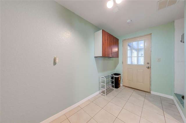 washroom featuring light tile patterned floors, baseboards, and visible vents