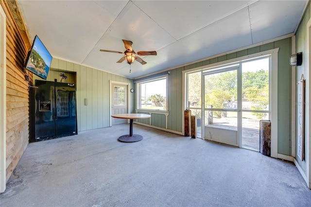 unfurnished sunroom featuring ceiling fan