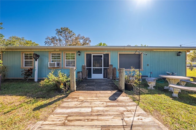 view of front of house with a front lawn and cooling unit