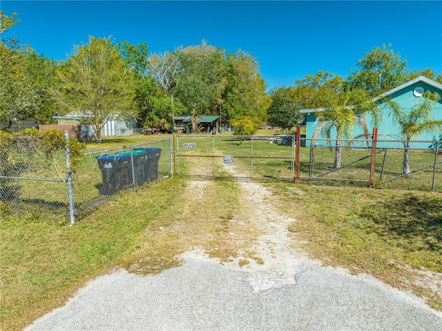 view of road with a gate, driveway, and a gated entry