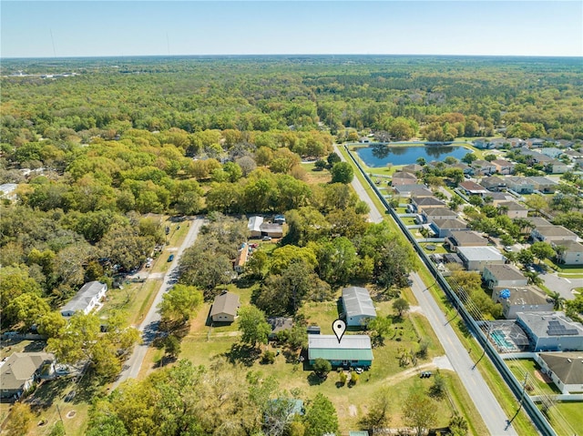 drone / aerial view with a water view and a wooded view