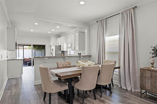 dining space featuring recessed lighting, wood finished floors, and ornamental molding