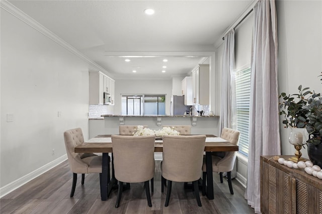 dining area with recessed lighting, ornamental molding, baseboards, and wood finished floors