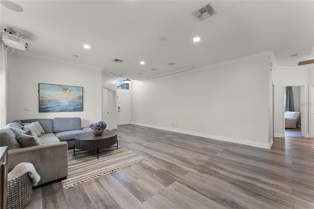 living area with visible vents, baseboards, ornamental molding, recessed lighting, and wood finished floors