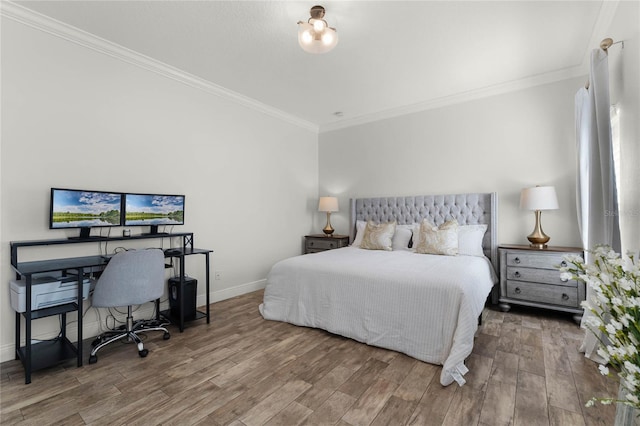 bedroom with baseboards, wood finished floors, and ornamental molding