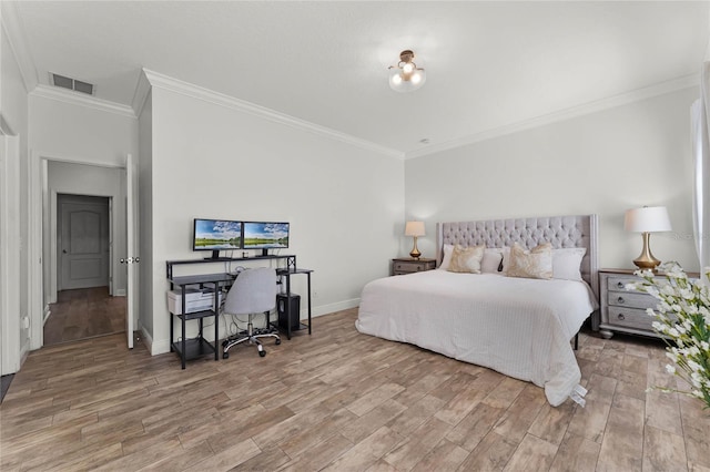 bedroom with visible vents, baseboards, light wood-style floors, and crown molding