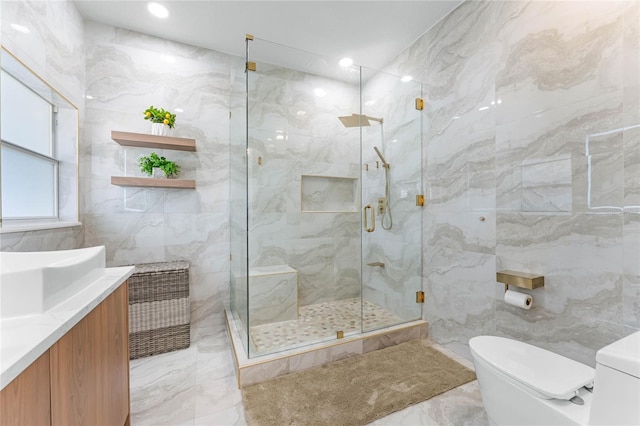 bathroom featuring toilet, marble finish floor, a stall shower, tile walls, and vanity