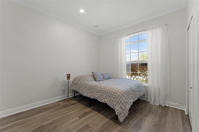 bedroom featuring recessed lighting, baseboards, wood finished floors, and ornamental molding