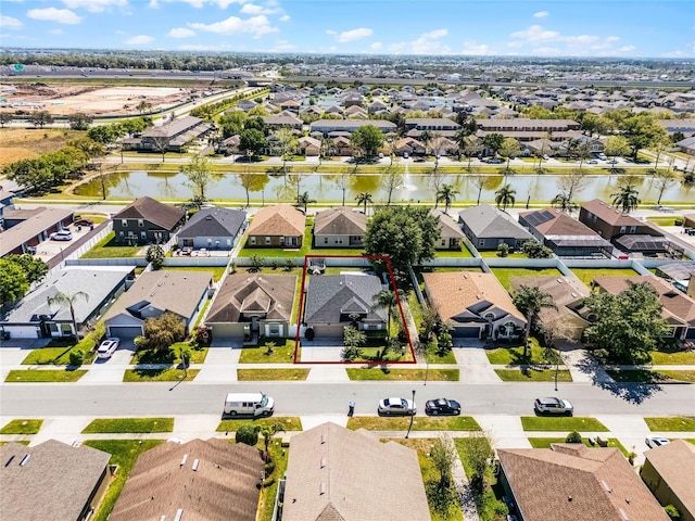 drone / aerial view featuring a residential view and a water view