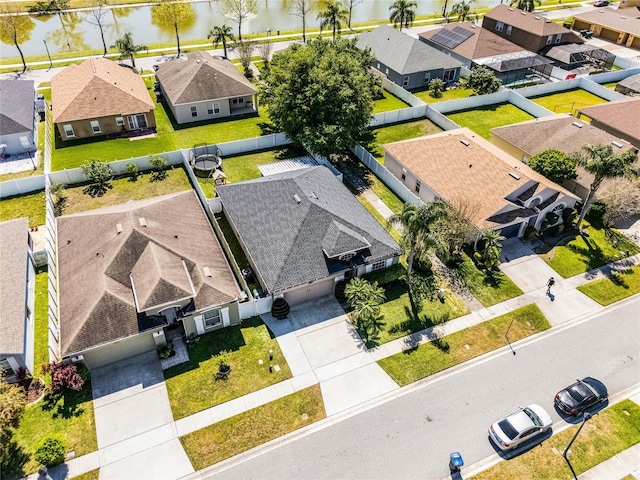 bird's eye view featuring a residential view and a water view