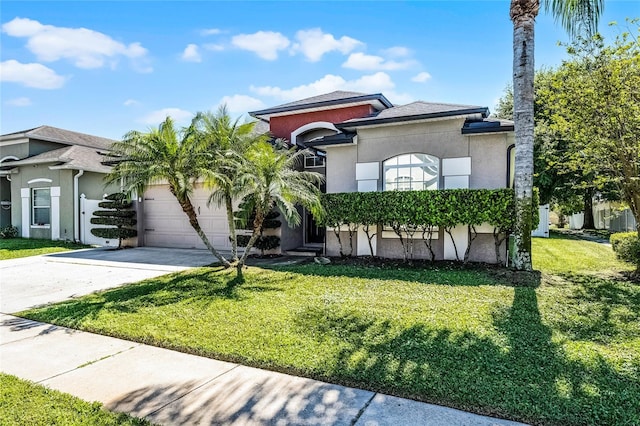 mediterranean / spanish-style house with stucco siding, driveway, a front lawn, and a garage