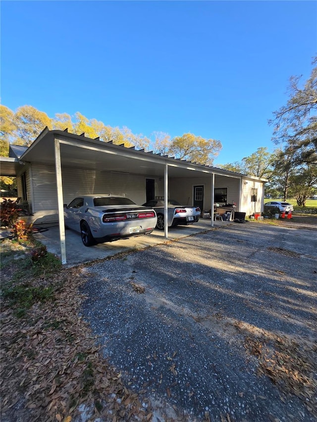 view of front of home with a carport and driveway